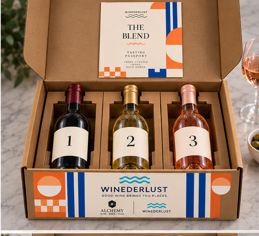 Open wine membership box with three bottles in die-cut kraft holders and tasting passport