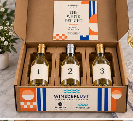 Open wine membership box with three bottles in die-cut kraft holders and tasting passport
